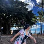 Surfing pose in front of the beach