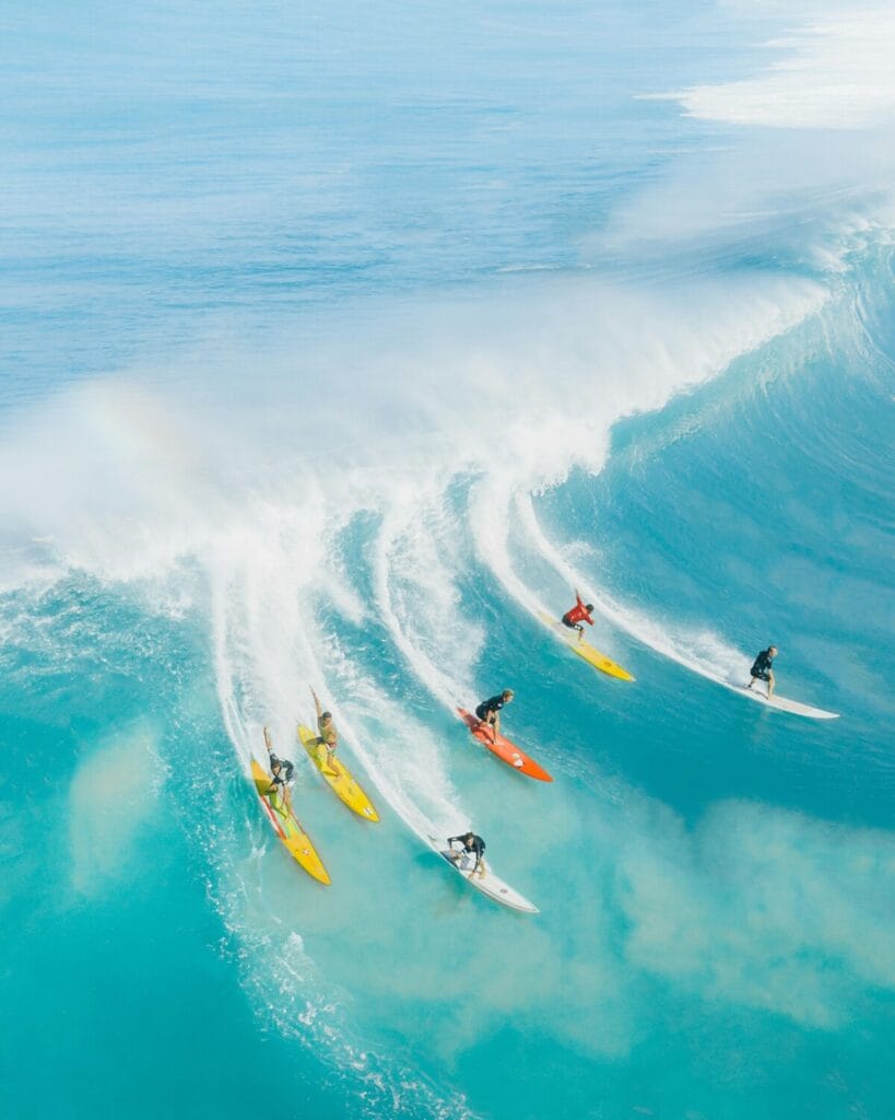 a group of people surfing in the ocean