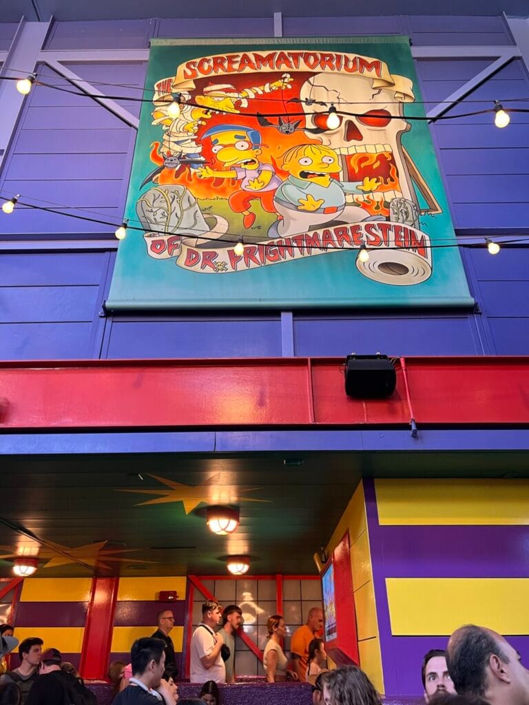 a group of people in front of a colorful building