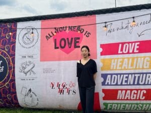 a woman standing in front of a banner at Night Lights Festival