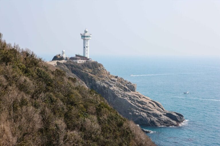 Lighthouse on rocky coastal landscape